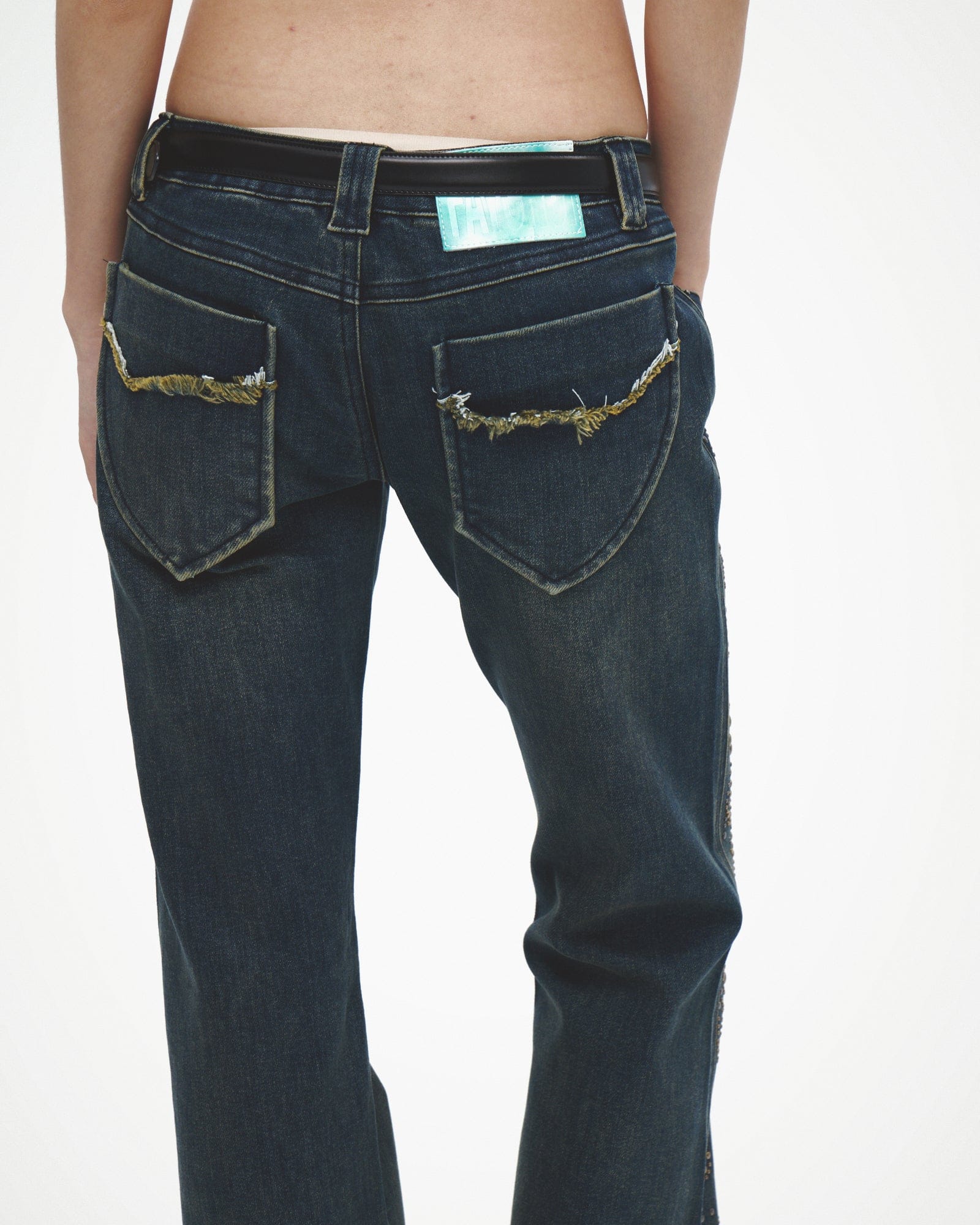 FAYCHUI Distressed Rivet Embellished Flared Jeans