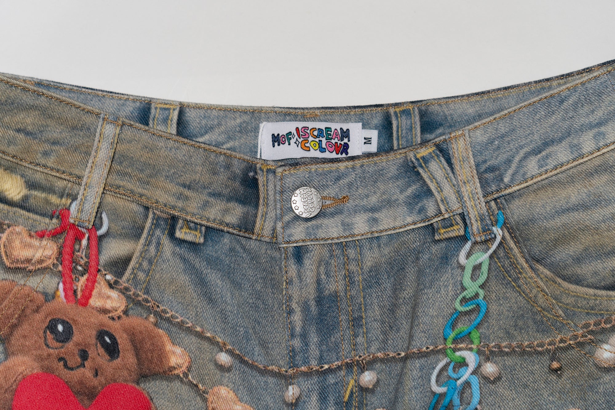 MOF Teddy Chain Graphic Distressed Curved Jeans