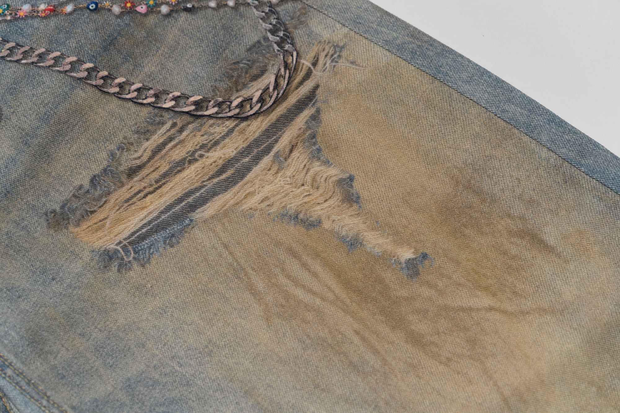 MOF Teddy Chain Graphic Distressed Curved Jeans