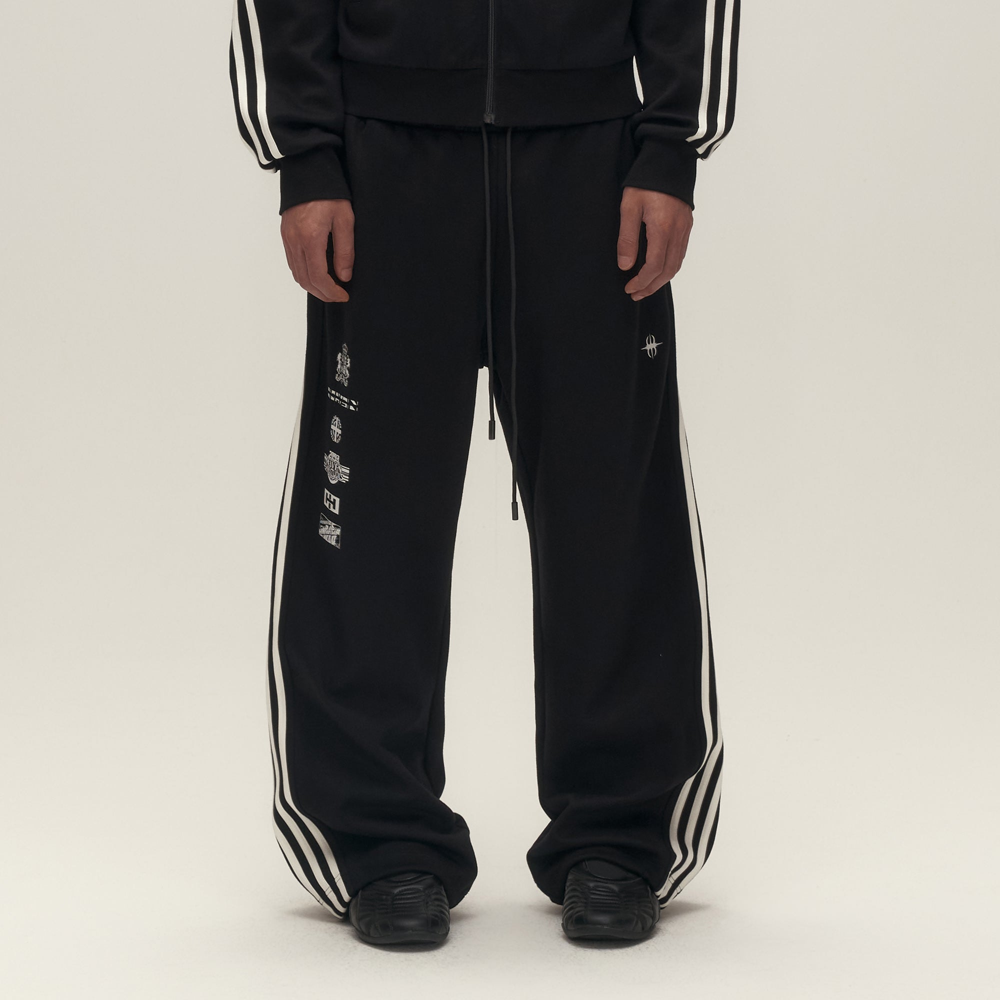 SAVAGEGROWTHWORLD Back-Arc Striped Graphic Track Pants, premium urban and streetwear designers apparel on PROJECTISR.com, SAVAGEGROWTHWORLD