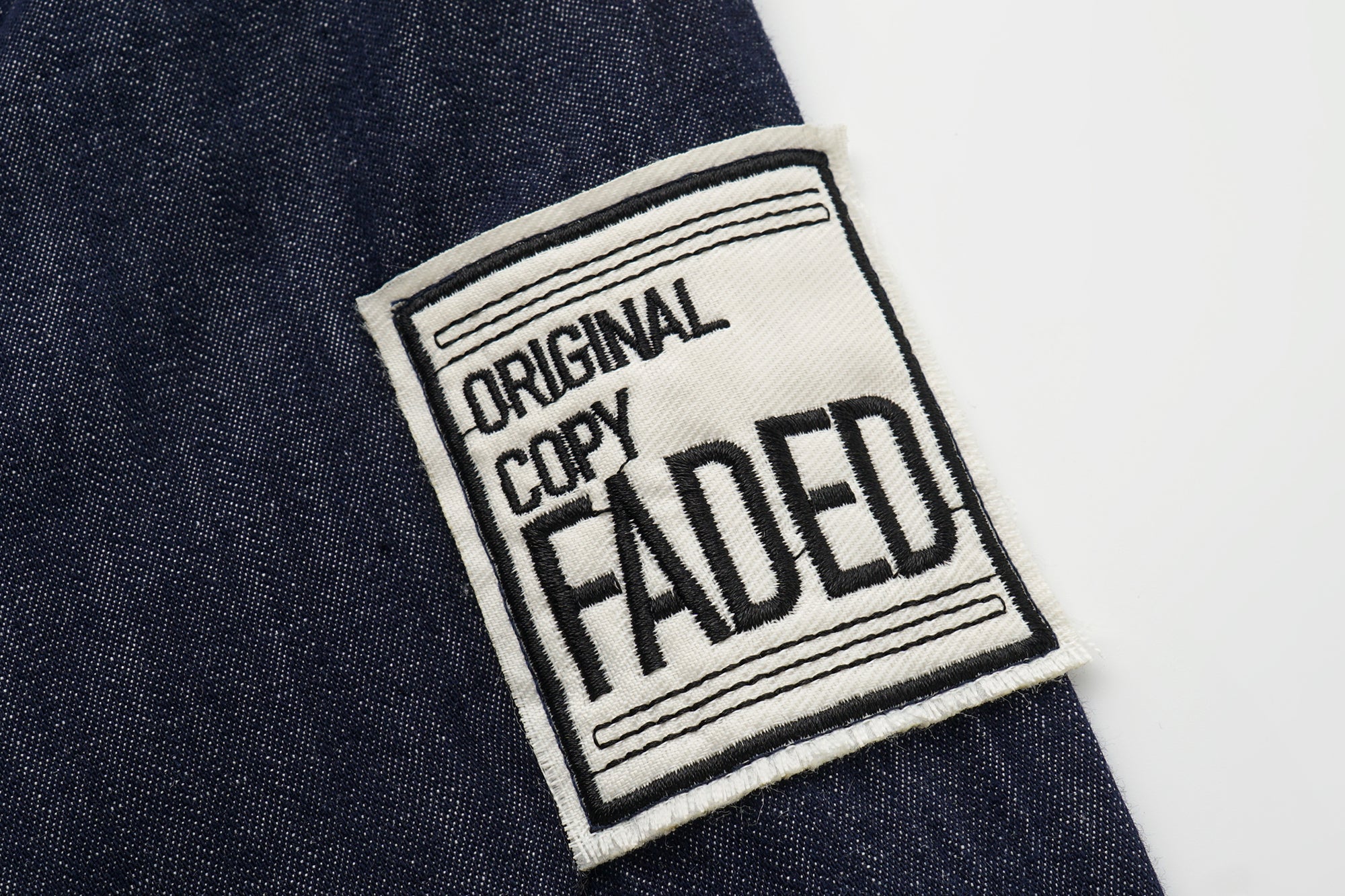 OINIMI Badge-Patch Waist-Cinched Denim Shirt